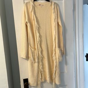 Long beige cardigan with frills and pockets